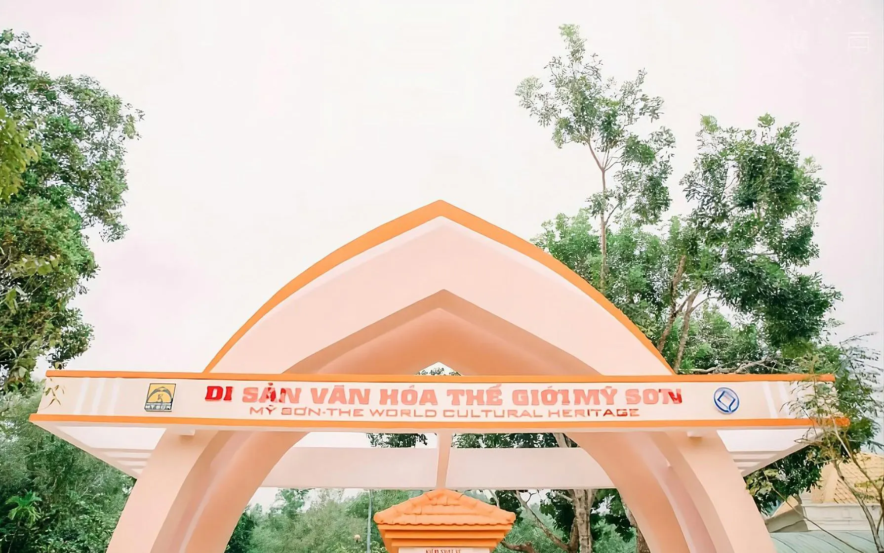 Entrance archway at My Son Sanctuary, Vietnam, with trees in the background.