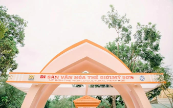 Entrance archway at My Son Sanctuary, Vietnam, with trees in the background.