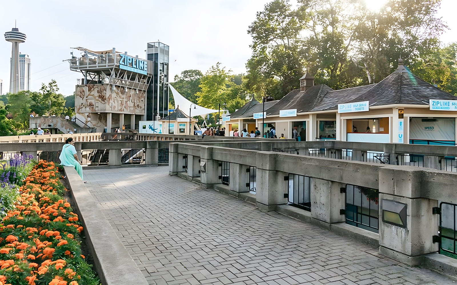 Zipline launch platform near Niagara Falls with ticket booths and observation tower.