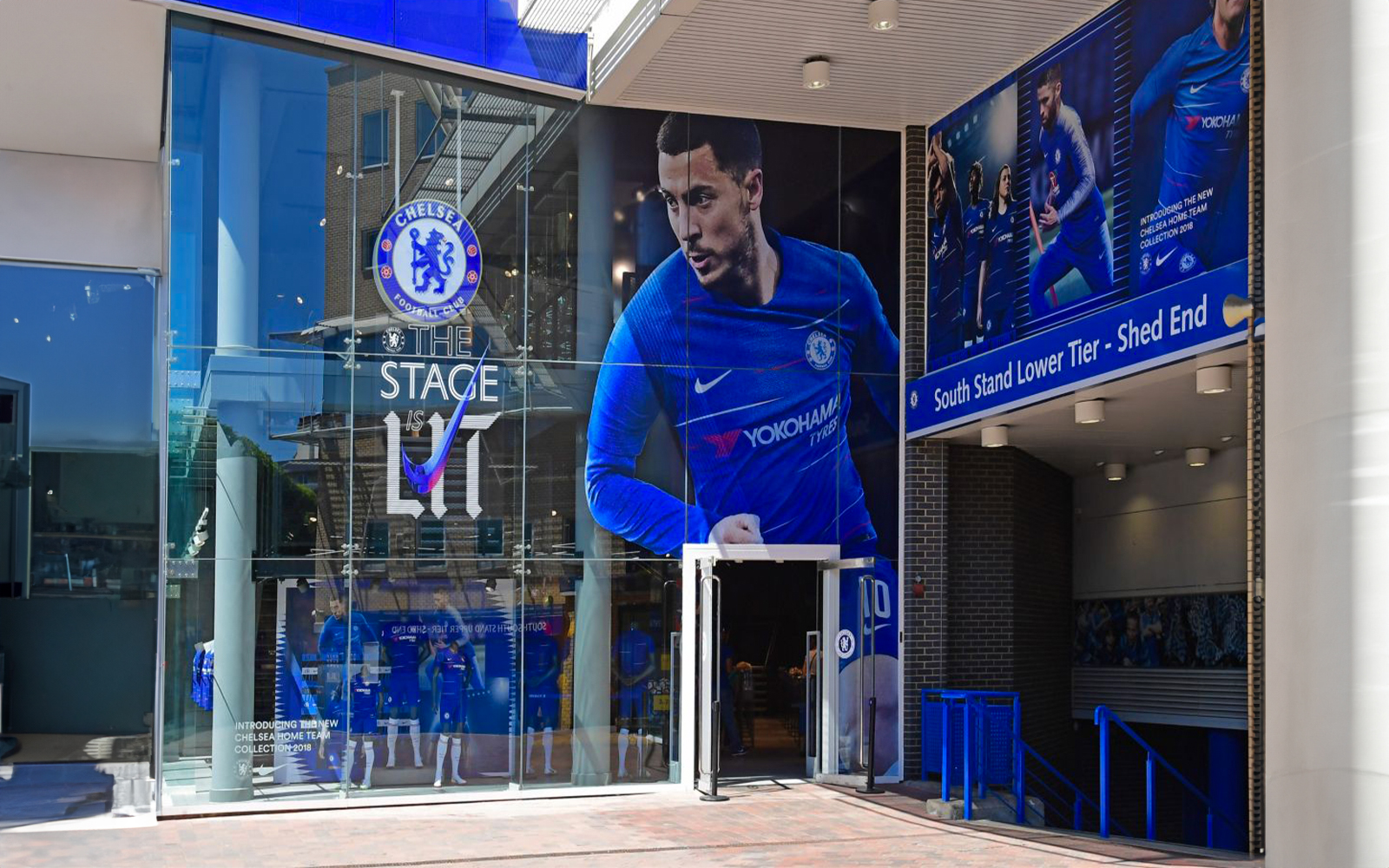Entrance to Chelsea FC Museum with large player mural and club logo.