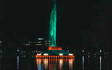 Night view of illuminated fountain at Lake Eola, Orlando, part of Haunted Orlando exploration game.