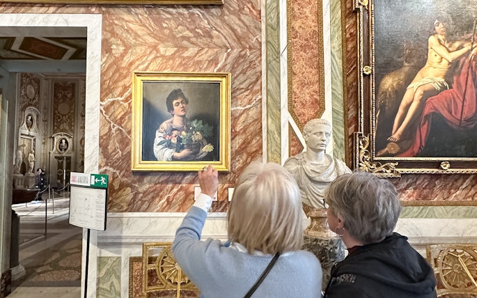 Visitors viewing Caravaggio's "Boy with a Basket of Fruit" at Borghese Gallery, Rome.