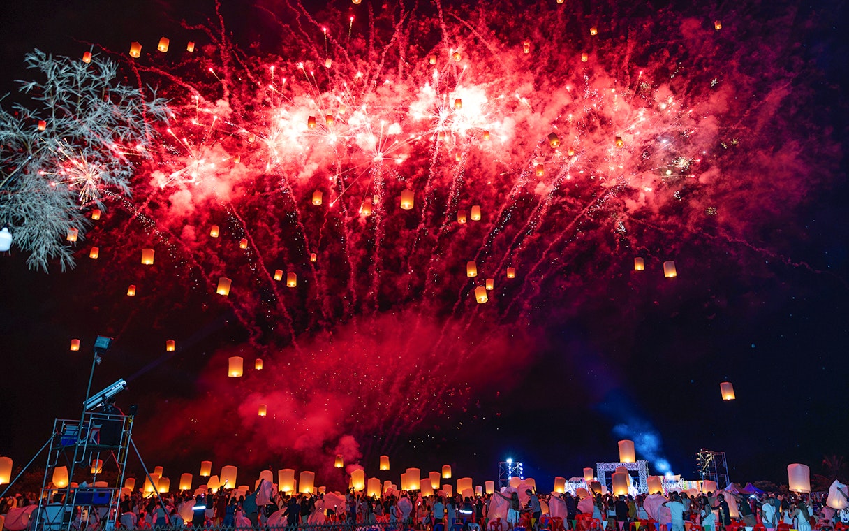 Fireworks and lanterns illuminate the night sky at Yi Peng and Loy Krathong Festival 2025.