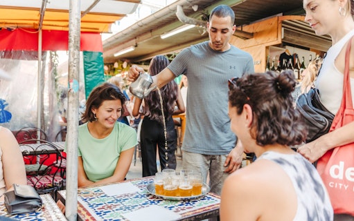 Paris market scene with a group enjoying tea during the Ultimate Paris Food Tour.