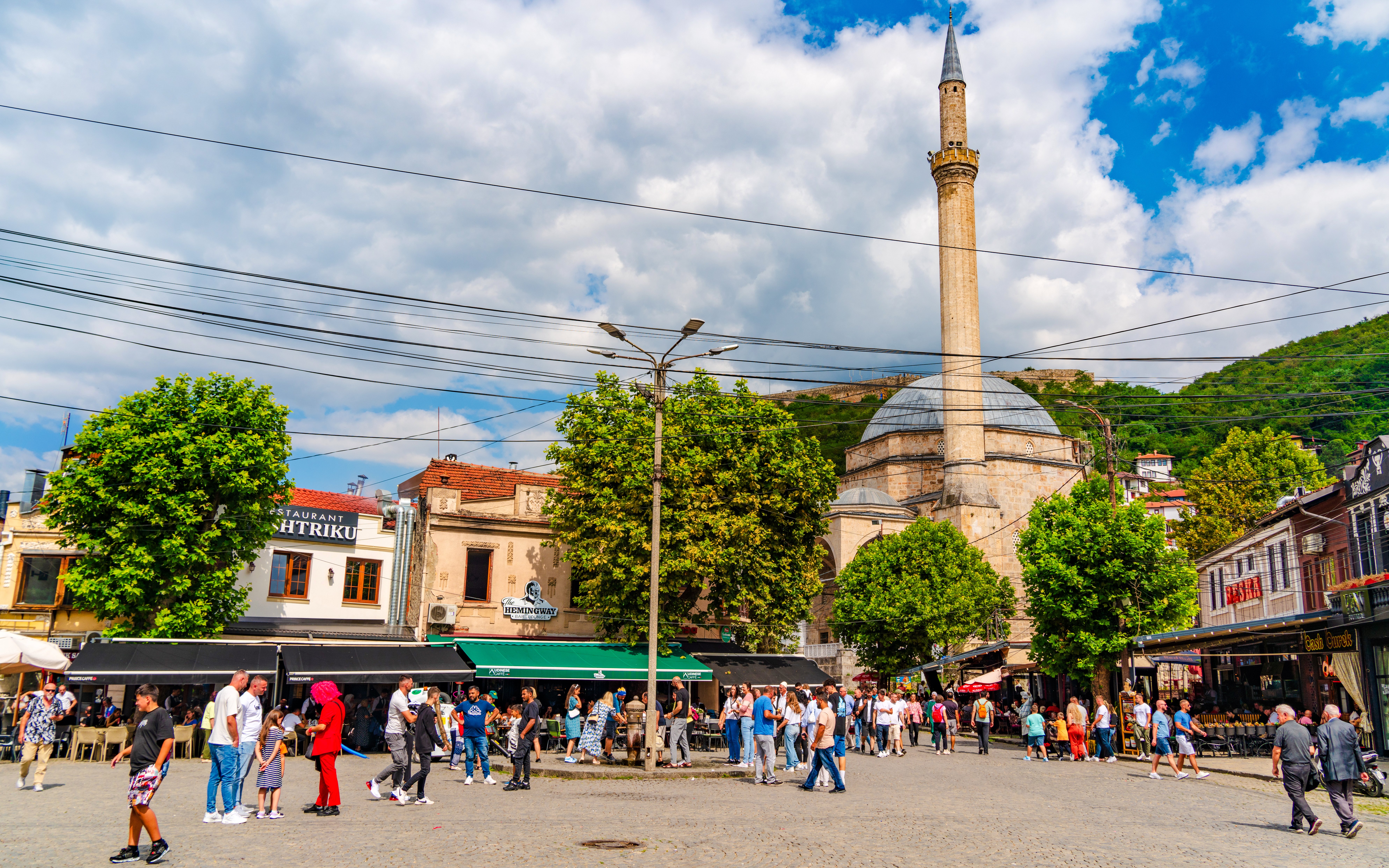 Crowd in Shadervan Square, Prizren, Kosovo, with Sinan Pasha Mosque in the background.