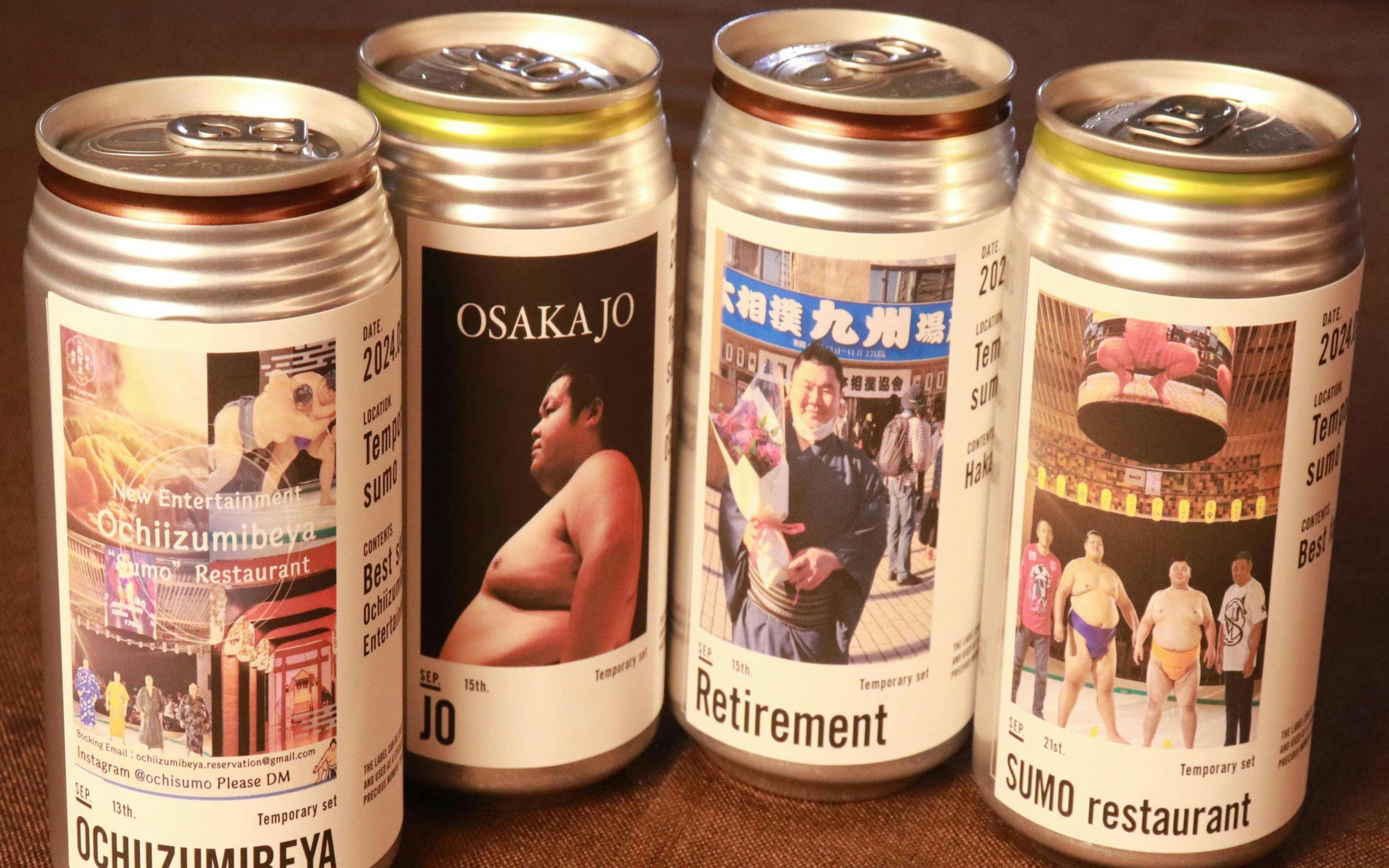 Cans featuring sumo-themed labels from Ochiizumibeya, showcasing sumo wrestlers and events.