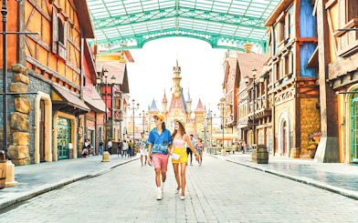 Guests walking through VinWonders theme park with castle in background.