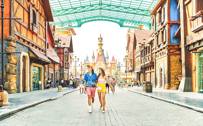 Guests walking through VinWonders theme park with castle in background.