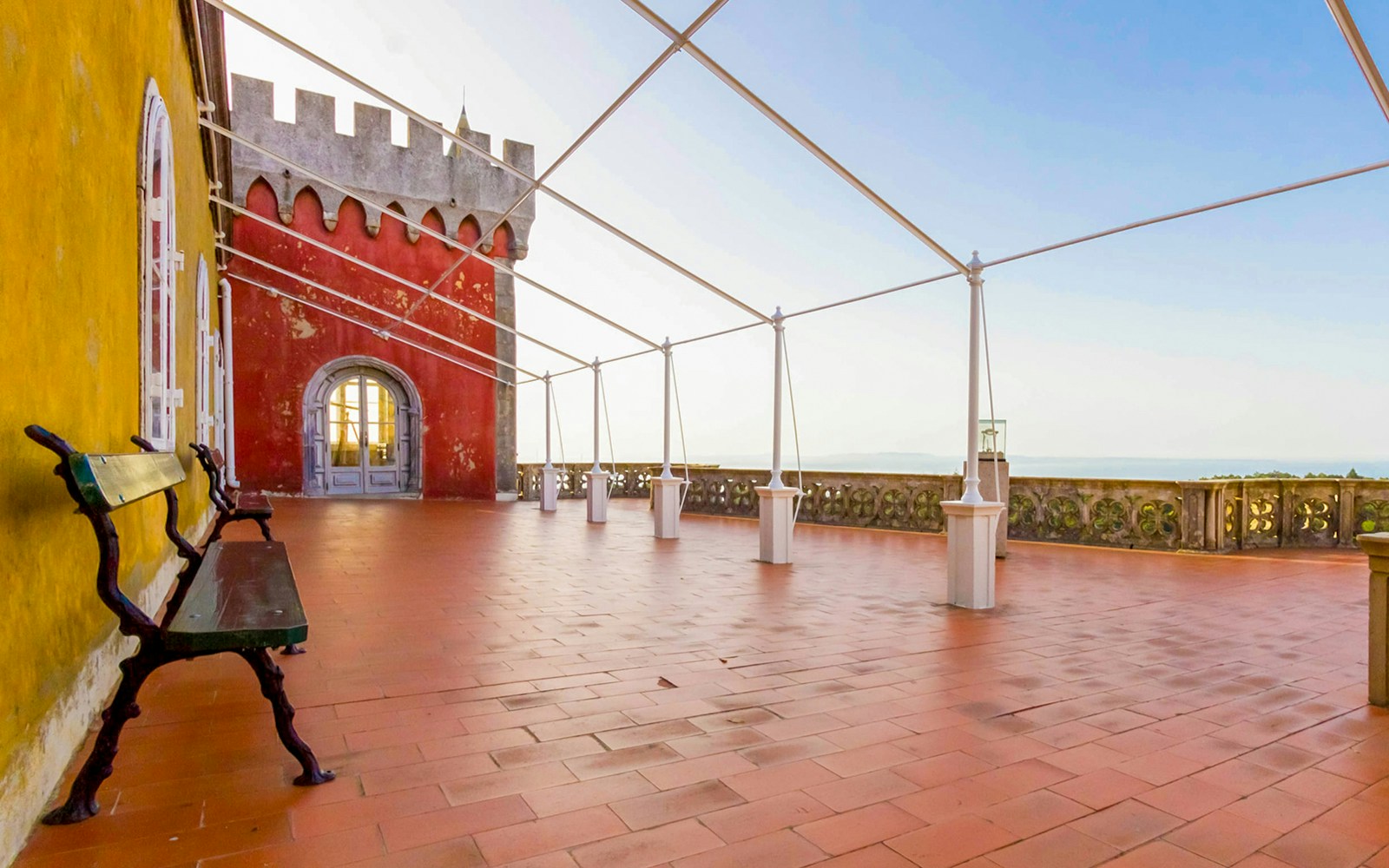 Queen's terrace at Pena Palace with colorful walls and scenic views in Sintra, Portugal.