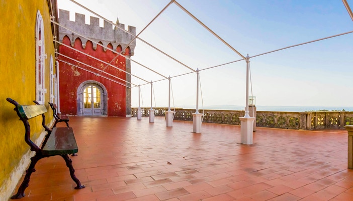 Queen's terrace at Pena Palace with colorful walls and scenic views in Sintra, Portugal.