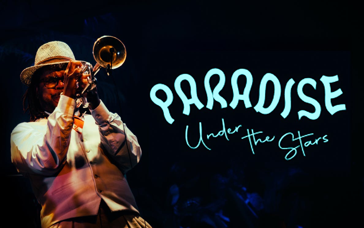 Musician playing trumpet at Paradise Under the Stars event.