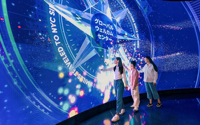 Visitors interacting with digital display at Welcome Wall, One World Observatory, New York City.