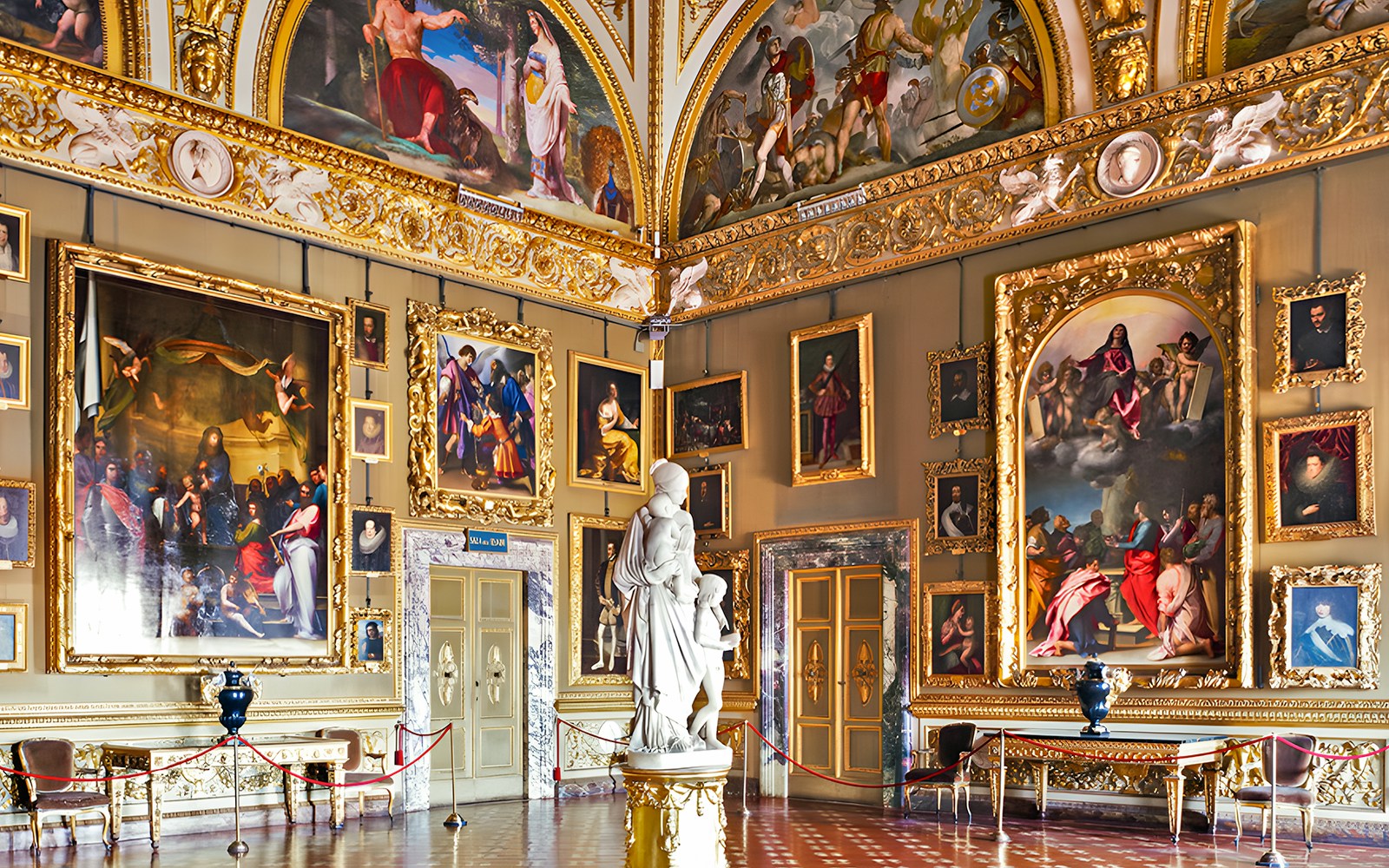 Pitti Palace interior with ornate paintings and sculptures, Florence, Italy.