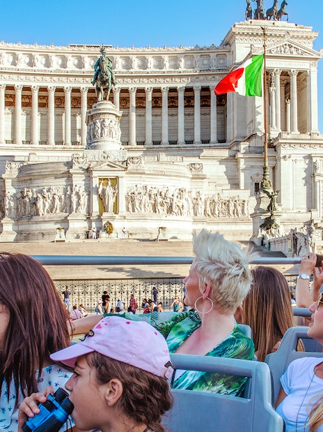 People on a HOHO bus viewing the Victor Emmanuel II Monument in Rome.