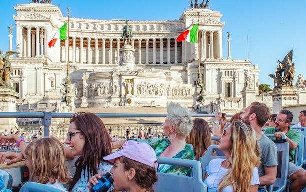 People on a HOHO bus viewing the Victor Emmanuel II Monument in Rome.
