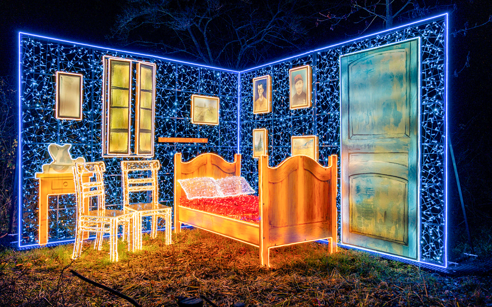 Lumina Park Wonderworld installation featuring illuminated bedroom scene with bed and chairs.