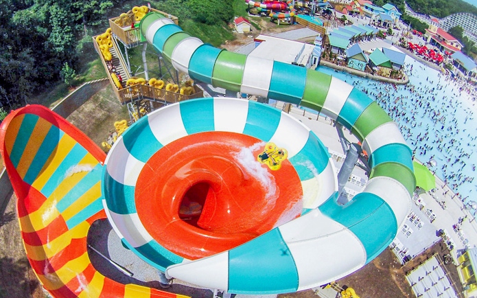 Water slide at Six Flags Over Georgia with people enjoying the ride.