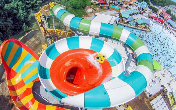 Water slide at Six Flags Over Georgia with people enjoying the ride.