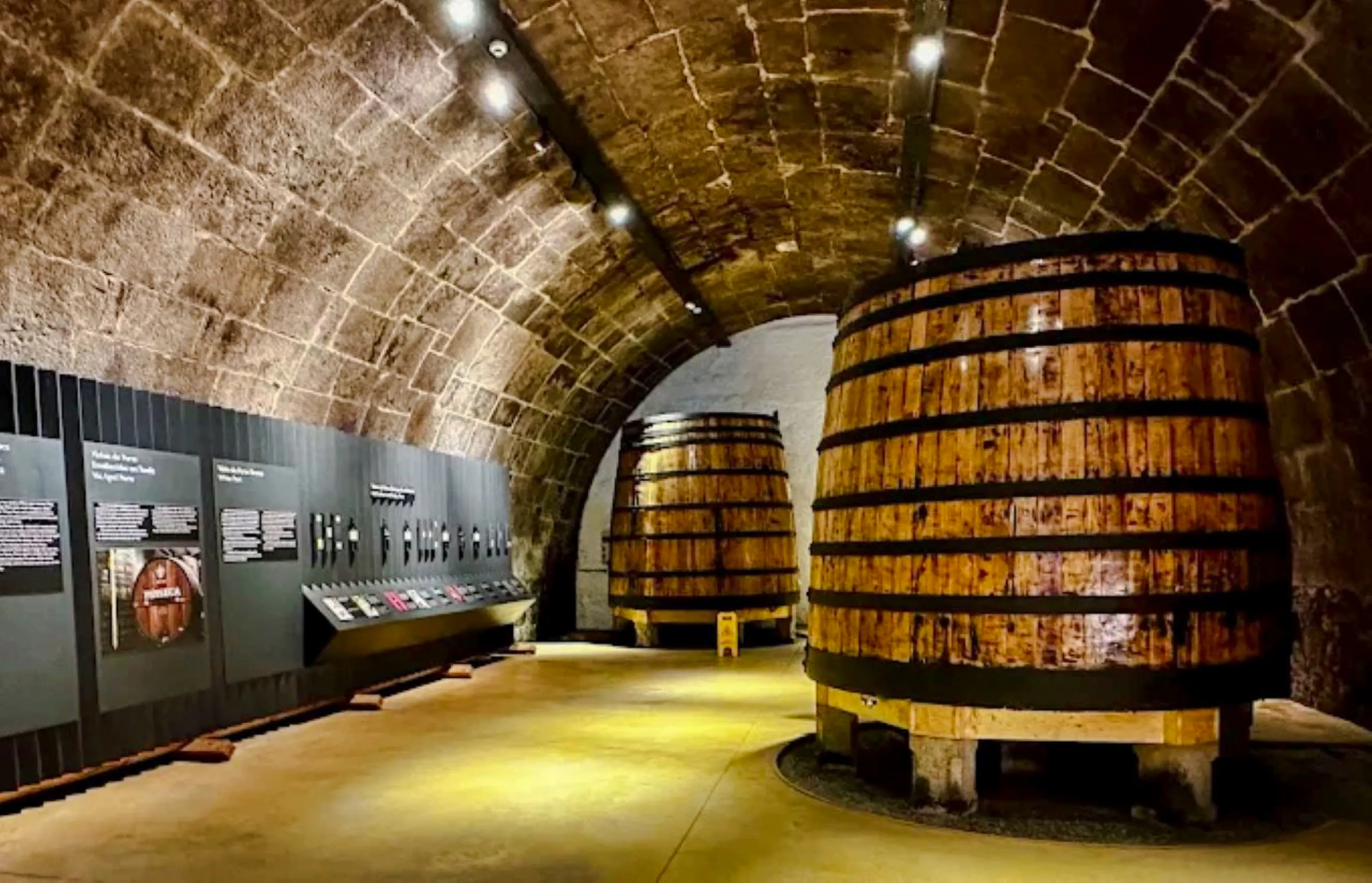 Wine barrels in a stone cellar at Caves do Vinho do Porto, Porto.