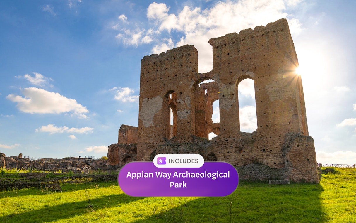 Ancient ruins at Appian Way Archaeological Park under a bright blue sky.