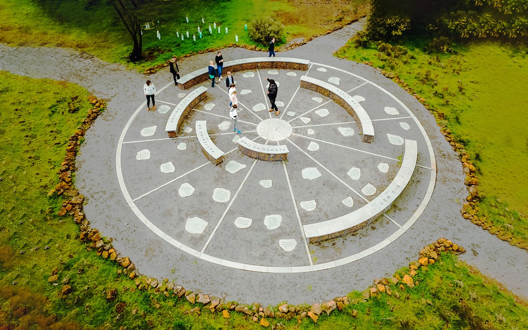 Guide explaining cultural site at Budj Bim National Park, Australia.
