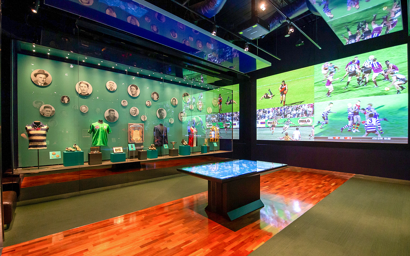 MCG sports memorabilia display with historic jerseys and player photos.