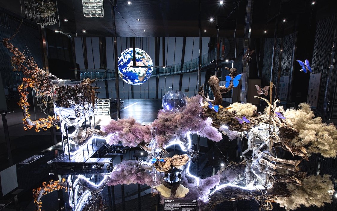 Miraikan permanent exhibition with Earth model and illuminated nature display.