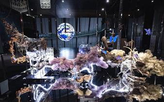 Miraikan permanent exhibition with Earth model and illuminated nature display.