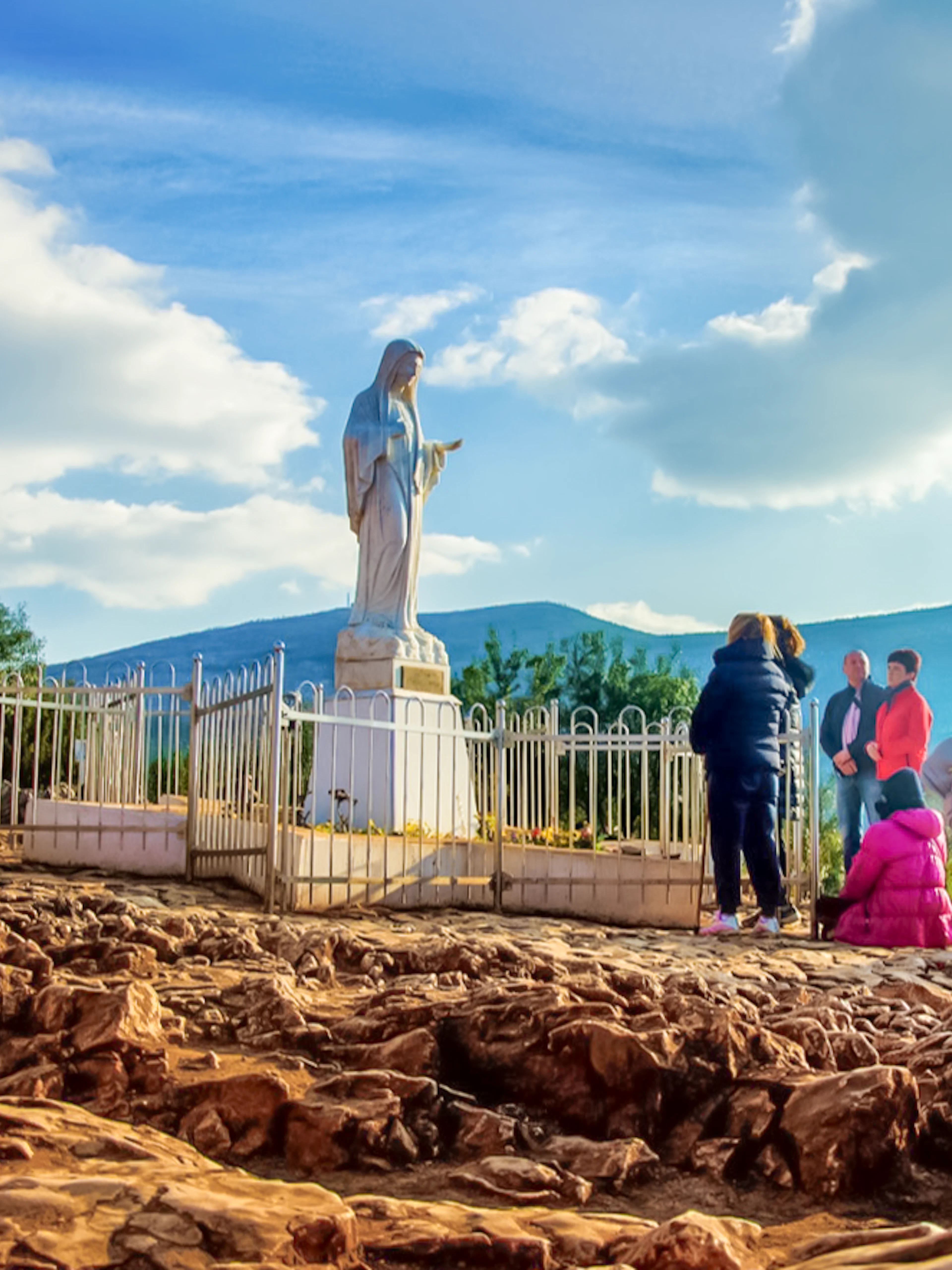 Pilgrims gather at the statue on Apparition Hill, Medjugorje, Bosnia and Herzegovina.