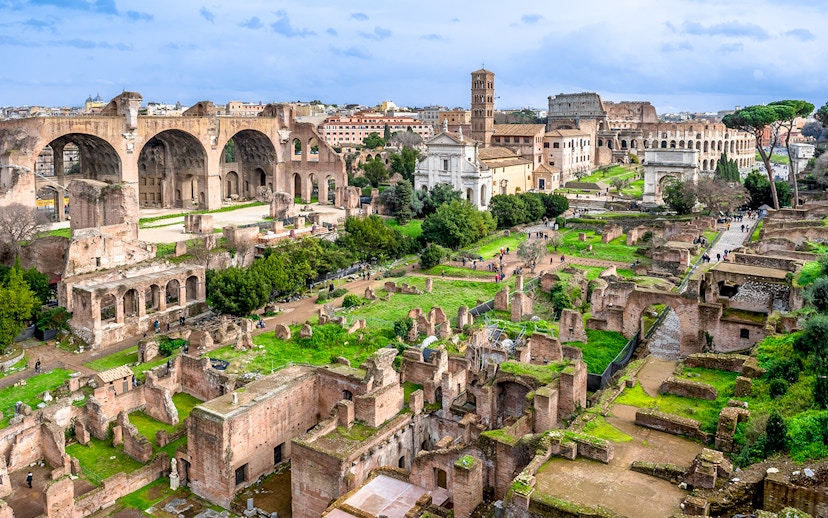 Colosseum, Palatine Hill, and Roman Forum ruins in Rome, Italy, viewed from above.