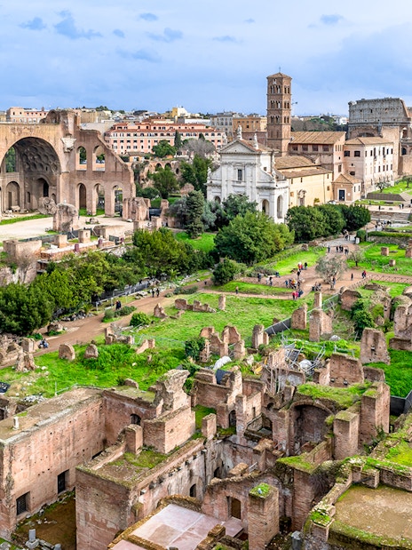 Colosseum, Palatine Hill, and Roman Forum ruins in Rome, Italy, viewed from above.