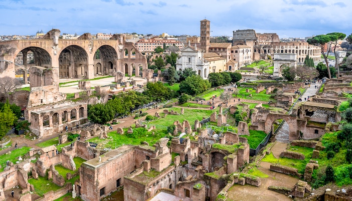 Colosseum, Palatine Hill, and Roman Forum ruins in Rome, Italy, viewed from above.
