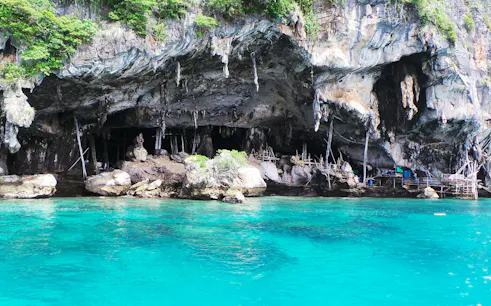 Phi Phi Islands cave with turquoise water, part of Phuket speedboat tour.