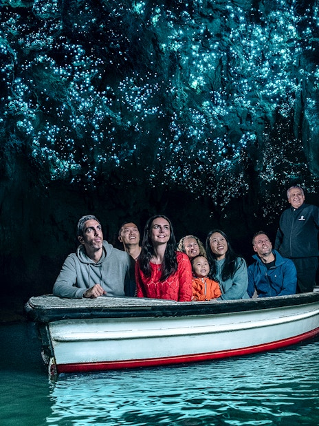 Group in boat under glowworms at Waitomo Caves, New Zealand.