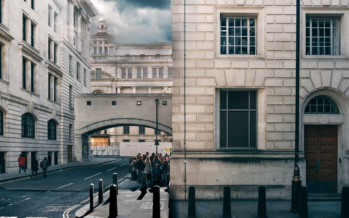Tour group exploring Harry Potter film locations near Millennium Bridge, London.