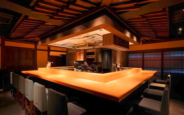 Yakitori Tsukiya dining area with wooden counter for 6/9-course yakitori meal.