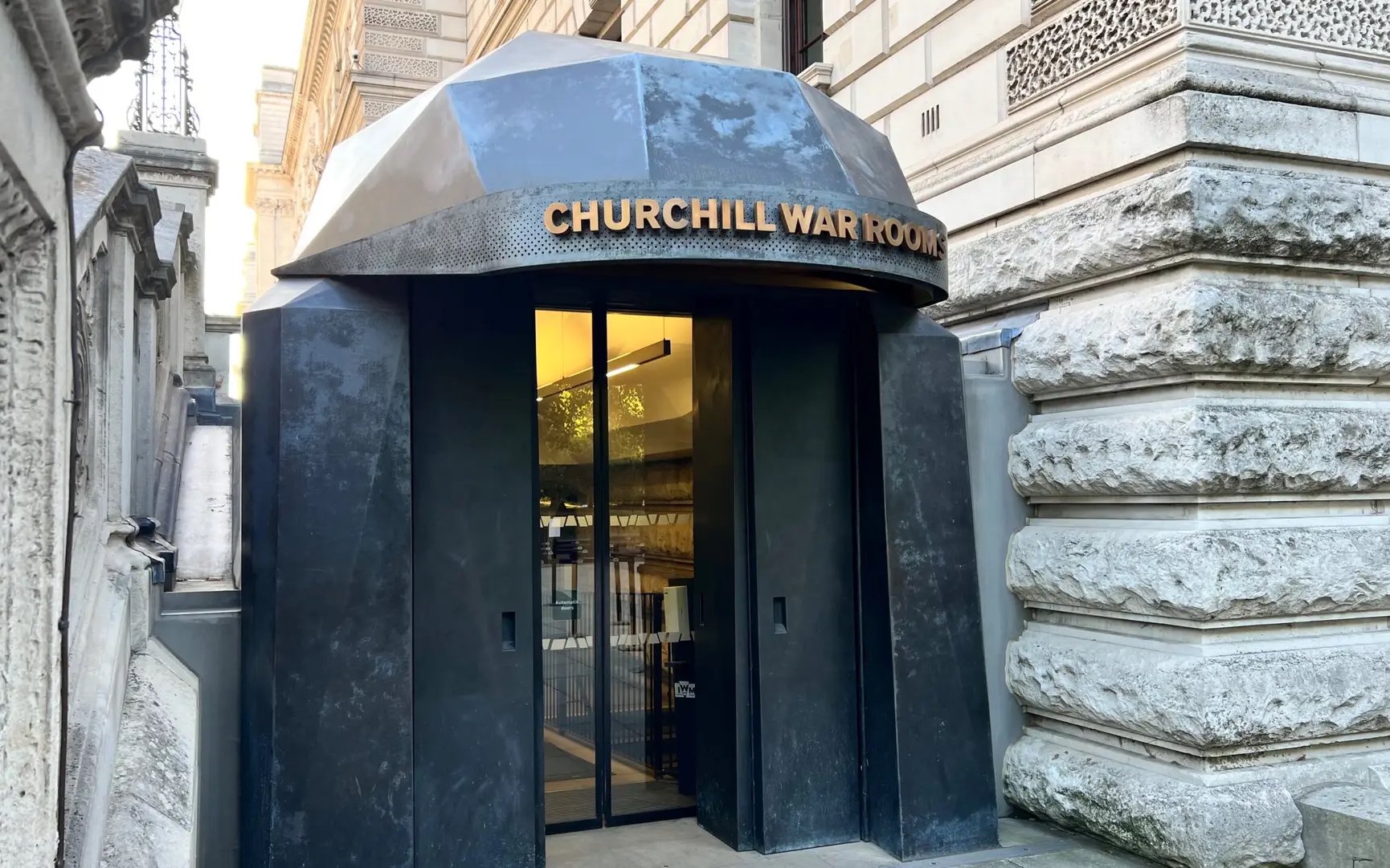 Entrance to Churchill War Rooms in London, featuring a black metal doorway.