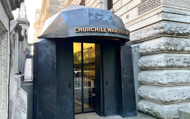 Entrance to Churchill War Rooms in London, featuring a black metal doorway.