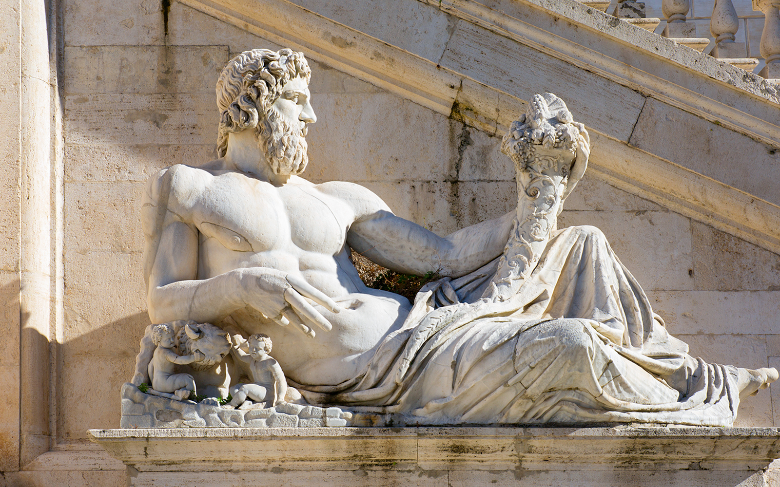 Statue of Tiber River God at Capitoline Museums, Rome, featuring reclining figure with cornucopia.