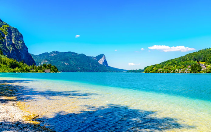 Clear lake with mountain backdrop in Salzkammergut, near Hallstatt, Austria.