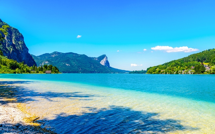 Clear lake with mountain backdrop in Salzkammergut, near Hallstatt, Austria.
