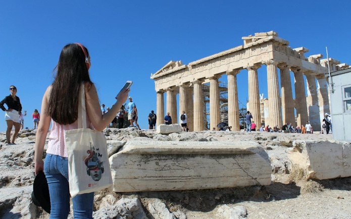 Tourists exploring the Parthenon at the Acropolis of Athens.