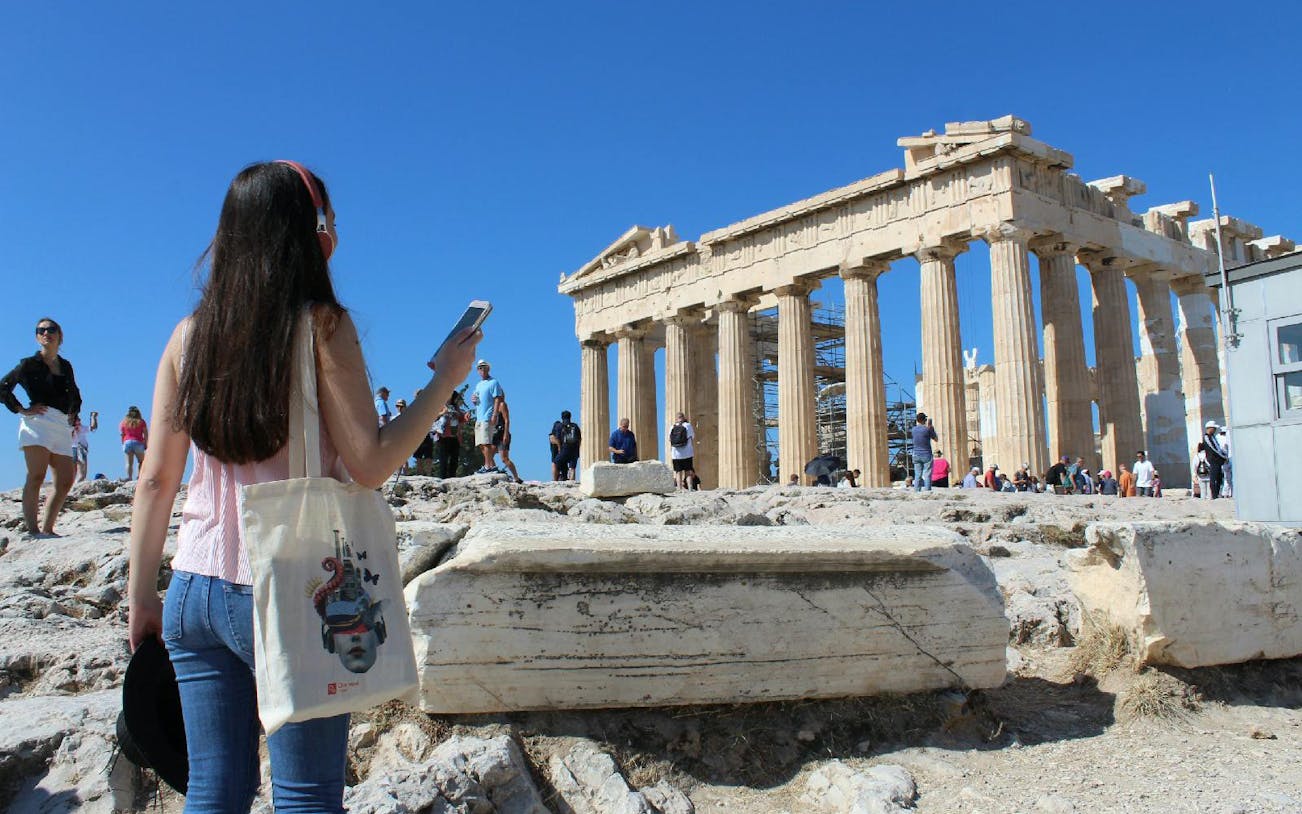 Tourists exploring the Parthenon at the Acropolis of Athens.