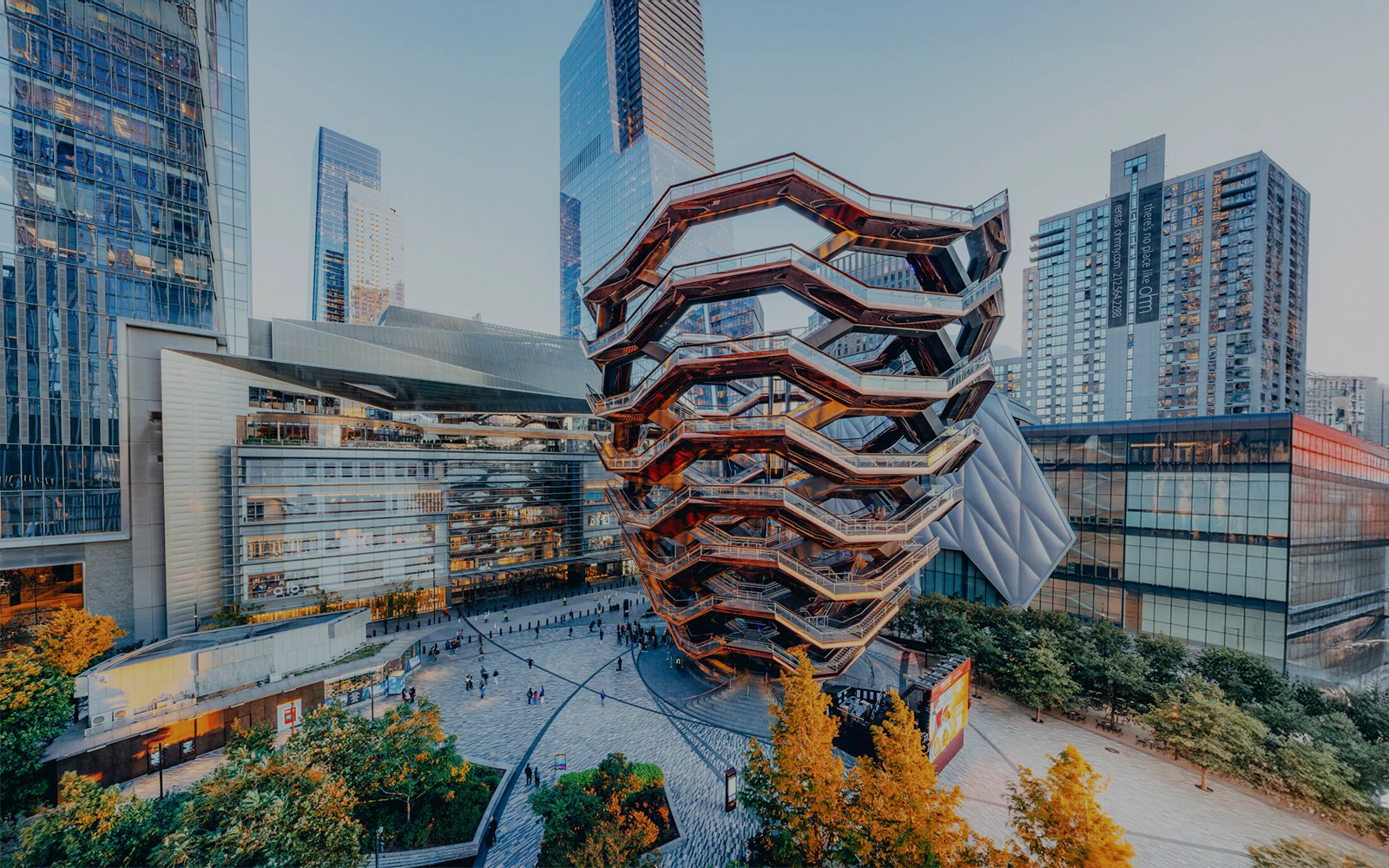 Exterior view of the Vessel in New York with surrounding skyscrapers.