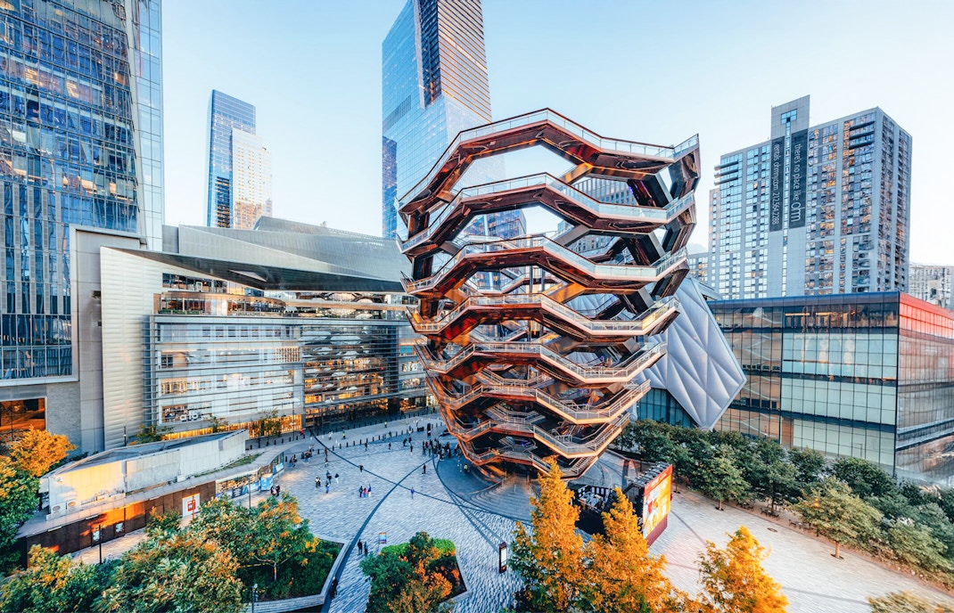 Exterior view of the Vessel in New York with surrounding skyscrapers.