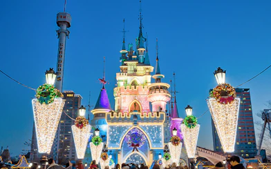 Lotte World castle illuminated at night with festive decorations, Seoul, South Korea.