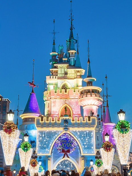 Lotte World castle illuminated at night with festive decorations, Seoul, South Korea.