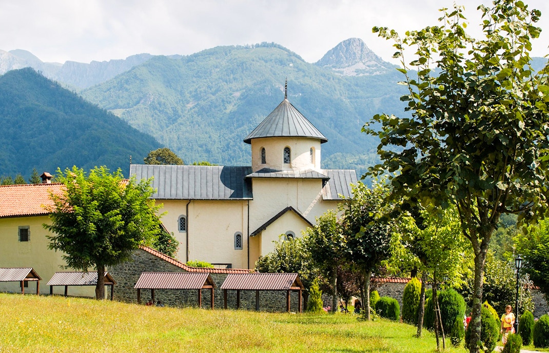Morača Monastery with mountainous backdrop and surrounding greenery.