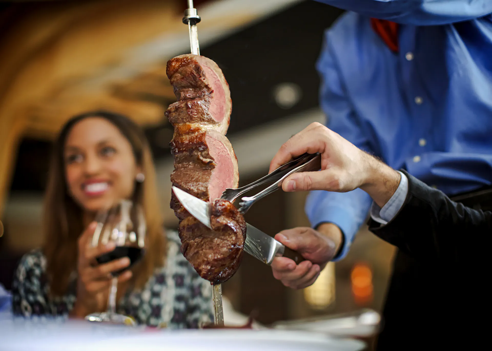 Server slicing meat at a Brazilian steakhouse in Rio de Janeiro.