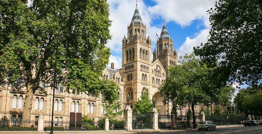 Natural History Museum's exterior with twin towers and trees in London.